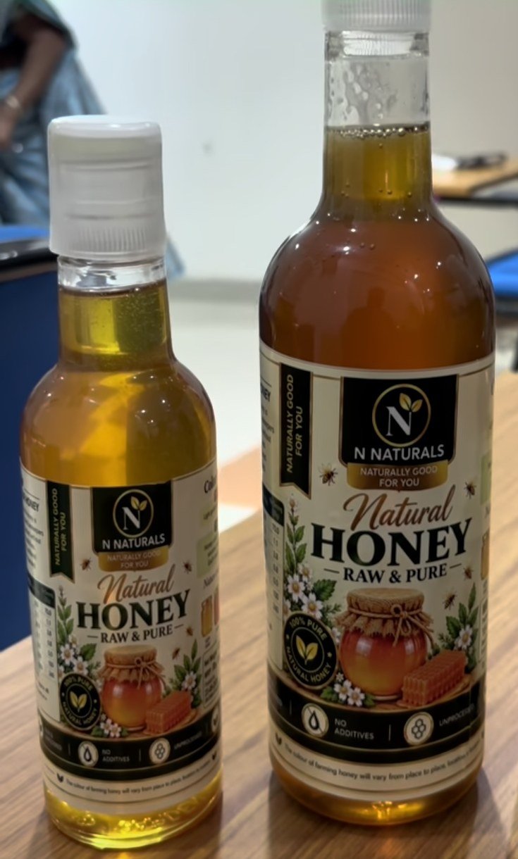 Two N Naturals Natural Honey bottles of different sizes on a table
